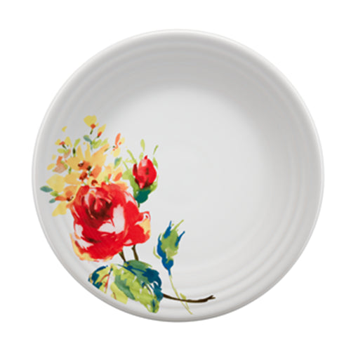 White plate with red flower on it. 