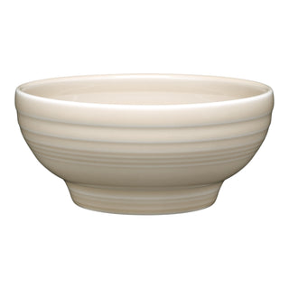 The Fiesta New Retired Small 5 1/8 Inch Footed Bowl (14 oz) features beige vitrified china with a glossy finish and subtle horizontal ridges, displayed on a white background.