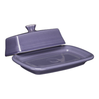 The Fiesta Lavender Extra Large Covered Butter Dish (8 1/8" x 5 1/8") features a rectangular, purple ceramic design with a matching lid, glossy finish, subtle ridges, and is dishwasher safe. Made in the USA.