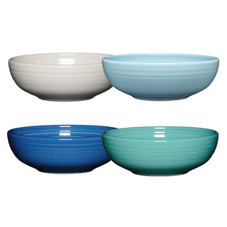 The Fiesta (FTC) Mixed Coastal Blue Bistro Coupe 7 5/8-Inch 38OZ Medium Bowls, Set of 4, includes ceramic bowls in white, light blue, dark blue, and teal with a glossy finish and flared rims. Each bowl is dishwasher safe.