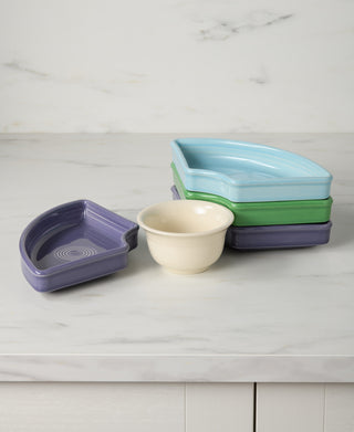 The Fiesta Lavender Bloom Mixed Color 5-Piece Entertaining Set features colorful wedge trays, a matching purple dish, and a bouillon bowl—perfectly arranged on your countertop for your next gathering.