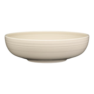 The Fiesta Bistro Coupe 10 1/2 Inch Extra Large Bowl (96 oz) is an off-white ceramic serving bowl with a smooth finish and subtle horizontal ridges near the rim. Made in the USA, it's shown against a white background.