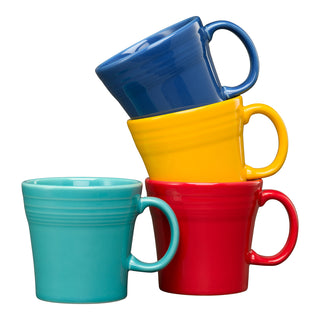 The Fiesta Mixed Vibrant 15 OZ Set of 4 Tapered Mugs features blue, yellow, turquoise, and red dishwasher-safe mugs, stacked in a leaning tower on a white background to bring color to any kitchen.