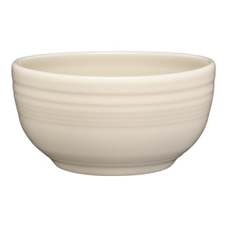 The Fiesta Bistro Coupe 5 1/2 Inch Cereal Bowl in Linen holds 22 oz, features a smooth ceramic surface with subtle horizontal ridges near the top, is dishwasher safe, and is shown against a white background.