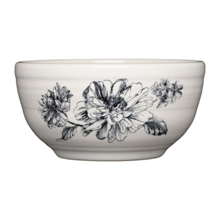 The Fiesta Botanical Floral Black Bistro Coupe 5 1/2 Inch Cereal Bowl (22 oz) is a white ceramic, microwave-safe bowl featuring a detailed black floral design with large, blooming flowers and leaves on the side.
