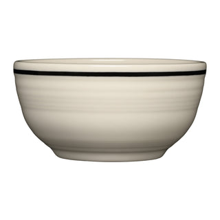 The Fiesta Black Band Bistro Coupe 5 1/2 Inch Cereal Bowl, 22 oz, is a lead-safe vitrified china bowl in off-white with a subtle horizontal groove pattern and a single thin black line near the rim, shown on a white background.