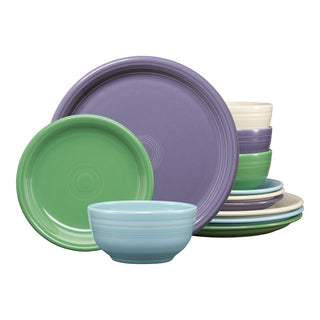 The Fiesta Lavender Bloom Mixed Color Bistro Coupe 12-Piece Dinnerware Set, Service for 4, features pastel plates and bowls in green, lavender, blue, cream, and light purple with a modern ribbed circular design.