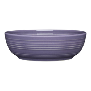 The Fiesta Lavender Coupe 6 3/4 Inch Salad Bowl (24 OZ) features a round, shallow ceramic design in matte lavender with exterior ridges. Dishwasher safe, it’s shown on a white background.