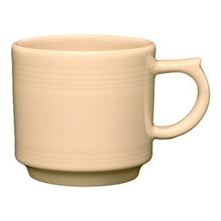 The Retired Fiesta 16 OZ Stackable Mug by Fiesta (FTC) is an ivory ceramic mug made in the USA, featuring a round handle and subtle horizontal ridges near the top, displayed against a white background.