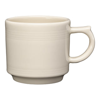 The Fiesta 16 OZ Stackable Mug by Fiesta, shown in Linen, features a large handle and subtle horizontal ridges—ideal for a coffee bar setup. Set against a white background.