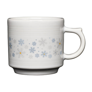 The White Snowflakes 16oz Stackable Mug by Fiesta features a white ceramic design adorned with light blue and gray snowflakes accented by small yellow dots, displayed against a plain white backdrop. Made from lead-safe china by Fiesta, this mug blends festive style with everyday convenience.