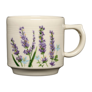 The Fiesta Lavender Bloom 16oz Stackable Mug features a handle and showcases a charming design of purple lavender flowers, green stems, and delicate blue blossoms on a pristine white background. Crafted from durable vitrified china, this mug combines everyday practicality with beautiful style.