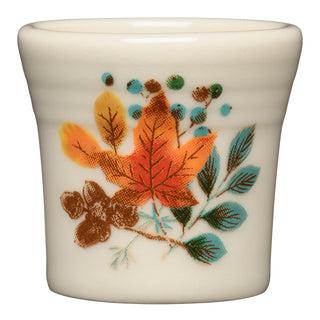 The Autumn Fields 1 1/2 OZ Ceramic Shot Glass by Fiesta (FTC) features an autumn design with colorful leaves, blue berries, and green foliage. This lead-safe shot glass is also dishwasher safe for easy cleaning.