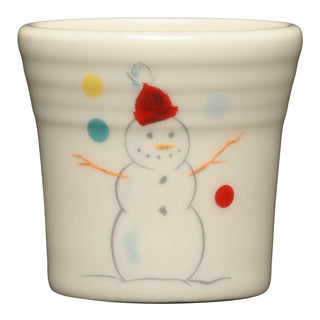 The Fiesta (FTC) Jolly Snowman 1 1/2 OZ Ceramic Shot Glass features a cream-colored vitrified china design with a playful snowman in a red hat and colorful dots, and is dishwasher safe.