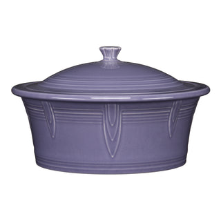 The Fiesta Lavender Large 10 Inch Round Covered Casserole (2.8 Quart) features purple ceramic with embossed lines on a white background. Oven and dishwasher safe, it’s ideal for easy cooking and cleanup.