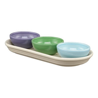 The Fiesta Lavender Bloom Mixed Color 4-Piece Condiment Set features a cream tray holding three mini bowls in purple, green, and light blue, all arranged side by side.