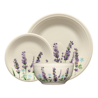 The Fiesta Lavender Bloom Classic Bistro 3-Piece Place Setting features a large plate, small plate, and bowl with lavender and blue floral designs on a cream background—perfect for adding botanical charm to your table. Service for 1.