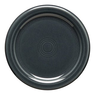 The Fiesta Retired 4 3/8 Inch Coaster in Slate features a smooth, glossy dark gray ceramic surface with concentric circular ridges, viewed from above on a white background. This lead-safe china is dishwasher safe for easy cleaning.