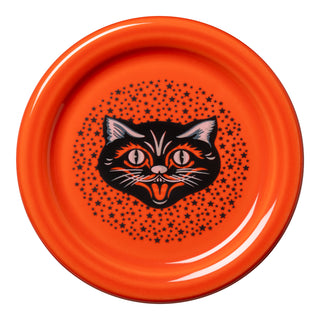 The Fiesta Black Cat 4 3/8 Inch Coaster and Mug Cover features an orange base with a black cat's head and wide eyes, surrounded by black stars—a playful addition to your holiday tabletop decor.