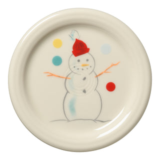 The Fiesta (FTC) Jolly Christmas 4 3/8 Inch Coaster and Mug Cover features a cream background with a simple snowman in a red hat, stick arms, and colorful dots. Made in the USA from lead-safe china.