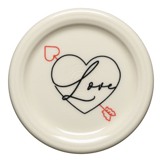The Fiesta (FTC) Valentine 4 3/8 Inch Coaster and Mug Cover features a cream ceramic design with a black heart outline, "Love" script, and a red arrow with heart tail. Ideal for collectors or as a mug cover.