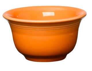 The Retired Fiesta 7 OZ Bouillon Bowl by Fiesta is a tangerine ceramic bowl with a wide rim and glossy finish, made in the USA and dishwasher safe, shown against a white background.