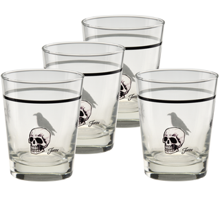 A set of four Fiesta Halloween Icons 15 oz. Tapered Double Old Fashion glasses from Moderne Glass are arranged together on a white background, each featuring a black skull and crow motif with a black rim near the top. Crafted in the USA, these high-quality glasses combine striking design with durable craftsmanship, making them perfect for any occasion.