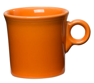 The Fiesta Retired Classic Ring Handle 10 1/4 OZ Mug in Tangerine, made in the USA, features a rounded handle and is displayed against a white background.