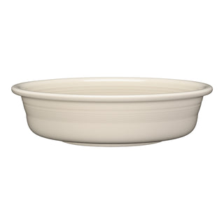 The Fiesta Classic Rim 10 1/2 Inch Extra Large Serving Bowl, 80 OZ, in Linen is a plain, round ceramic bowl with smooth sides and a slightly raised rim. Dishwasher safe, it appears cream-colored against a white background.