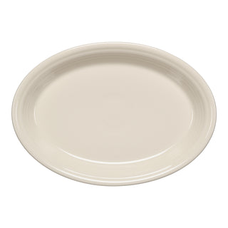 The Fiesta 13 5/8 Inch Large Oval Serving Platter in Linen features a smooth, glossy finish and a slightly raised rim. Made in the USA, this off-white platter by Fiesta is shown from above.