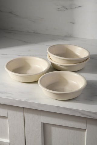 The Fiesta (FTC) Linen Set of 4 Classic Rim 6 7/8 Inch Cereal Bowl 19 OZ offers stylish, stackable dinnerware, pictured on a white marble countertop with a white cabinet and marble backsplash in the background.