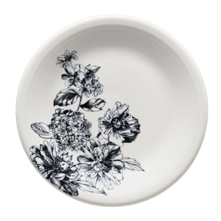 The Fiesta Botanical Floral Black Classic Rim 7 1/4 Inch Salad Plate is a round white ceramic plate with detailed black floral designs on one side; the rest remains elegantly plain. Made in the USA.