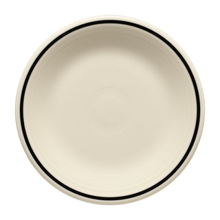 The Fiesta Black Band Classic Rim 7 1/4 Inch Salad Plate is a round, cream-colored ceramic plate with a simple black rim and subtle center circles, inspired by art deco dinnerware and shown from above on a white background.