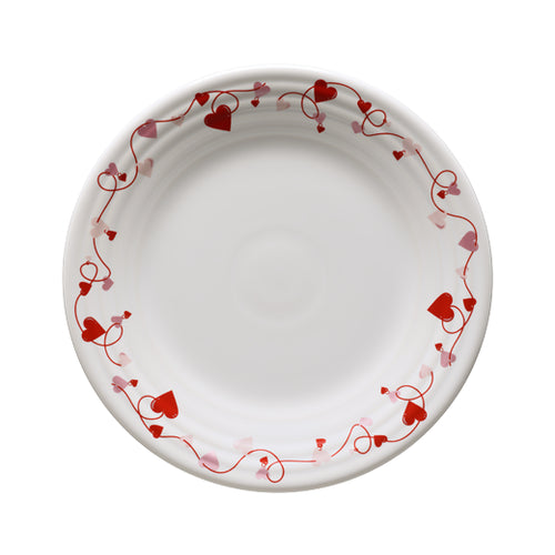 White plate with red hearts around the plate