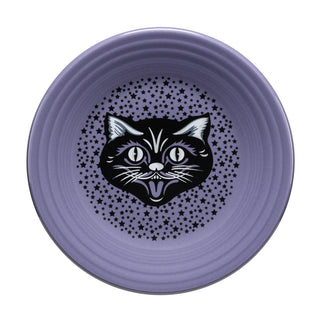 The Fiesta Black Cat Lavender Classic Rim 9 Inch Luncheon Plate, crafted in the USA from vitrified china, displays a black and white cartoon cat face at the center with a pattern of small black stars around it. It's also dishwasher safe for easy cleaning.