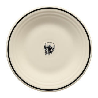 The Fiesta Halloween Icon Skull Classic Rim 9 Inch Luncheon Plate features a cream color with a thin black rim and central skull illustration, making it a perfect Halloween plate or unique addition to your skull collection.