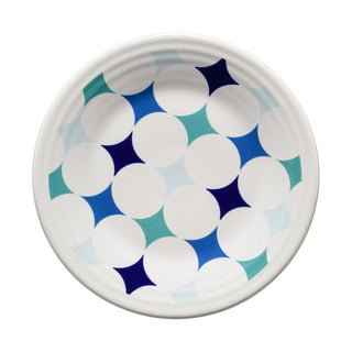 Add a bold accent to your table with the Fiesta Coastal Blues Kaleido Circles Classic Rim 9 Inch Luncheon Plate. This white ceramic plate features a modern, symmetrical design of blue, teal, and navy geometric star shapes layered over crisp white circles. Fiesta-compatible and ideal for contemporary dining, it brings striking style to any setting.