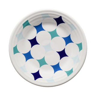 The Fiesta Coastal Blues Kaleido Circles Classic Rim 9 Inch Luncheon Plate features a repeating pattern of blue circles with star-shaped, four-pointed accents in shades of blue and teal, making it an elegant addition to any contemporary tabletop.