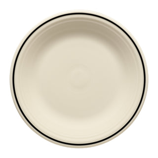 The Fiesta Black Band Classic Rim 10 1/2 Inch Dinner Plate is a round, cream-colored ceramic plate with a subtle concentric pattern and a black banded rim, shown from above against a white background.