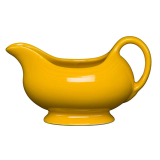 The New Retired Fiesta 18 1/2 OZ Gravy Sauceboat in Daffodil, crafted from lead-safe china and featuring a curved spout and handle, is perfect for serving sauces. Displayed on a white background.