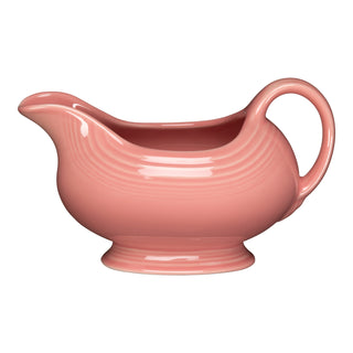 The New Retired Fiesta 18 1/2 oz Gravy Sauceboat in Peony features a curved handle, wide spout, and subtle ridged detail on a pedestal base. Crafted from lead-safe china by Fiesta and set against a white background.