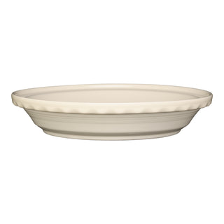 The Fiesta 10 1/4 Inch Deep Dish Pie Baker (44oz) is a white, round pie baker with fluted edge and smooth sides, made in the USA. Oven safe and displayed on a white background.