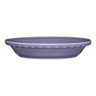 A side view of the Fiesta Lavender 10 1/4 Inch Deep Dish Pie Baker (44oz) shows its round, scalloped rim and smooth matte finish; this ceramic baker is dishwasher safe.