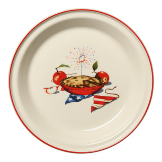 The Fiesta Americana Apple Pie 10 1/4 Inch Deep Dish Pie Baker (44oz) is a round ceramic dish with a red rim, featuring pie, apples, a sparkler, and an American flag on the bottom. Proudly made in the USA.