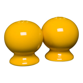 The New Retired Fiesta 2 5/8 Inch Salt and Pepper Shaker Set in cheerful Daffodil brightens any table with classic Art Deco style, showcasing the iconic quality of the Fiesta brand.