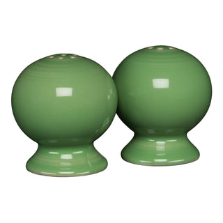 The New Retired Fiesta 2 5/8 Inch Salt and Pepper Shaker Set by Fiesta features two round, green ceramic shakers with a glossy finish and small holes on top, displayed side by side on a white background.