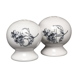 The Fiesta Botanical Floral Black 2 5/8 Inch Salt and Pepper Shaker Set features two round white ceramic shakers with black floral designs and bold S and P labels, making a charming addition to your Fiesta Dinnerware collection.