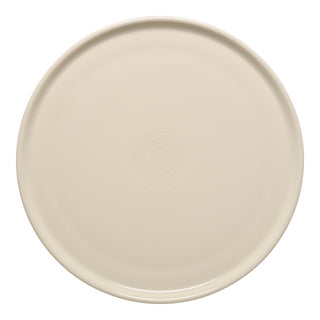 The Fiesta 12 Inch Round Baking and Serving Platter in Linen is a cream-colored ceramic plate with subtle concentric circles, oven safe and perfect as a baking tray, shown from above on a white background.