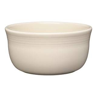 The Fiesta All-Purpose 6 Inch Gusto Bowl, 28 OZ, in Linen features a smooth, glossy finish and slightly flared rim. This off-white ceramic bowl is microwave and dishwasher safe, shown here on a white background.