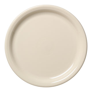 A round, cream-colored Fiesta Bistro Coupe 9 Inch Luncheon Plate in Linen with a glossy finish and subtle concentric circles, shown from above on a white background. Made in the USA.